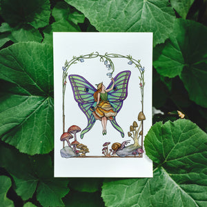 Illustration of a mushroom fairy with butterfly luna moth wings on archival cotton paper, surrounded by an art nouveau style arch of greenery, flowers and mushrooms.